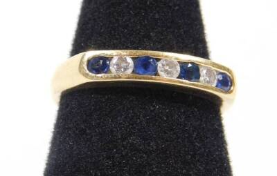 An 18ct gold half hoop eternity ring, set with sapphire and diamonds in tension setting, ring size N, 3.9g all in.