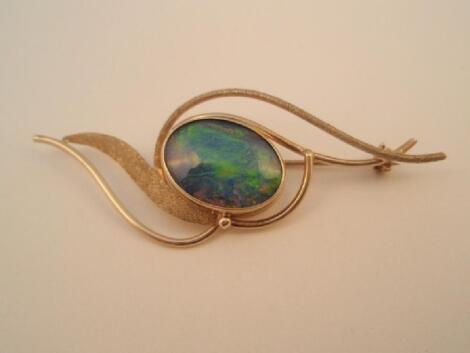 A brooch set with an oval opal of 18mm x 13mm approx