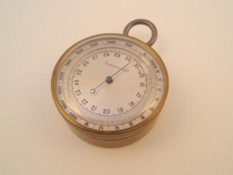 A brass cased pocket barometer with altimeter scale