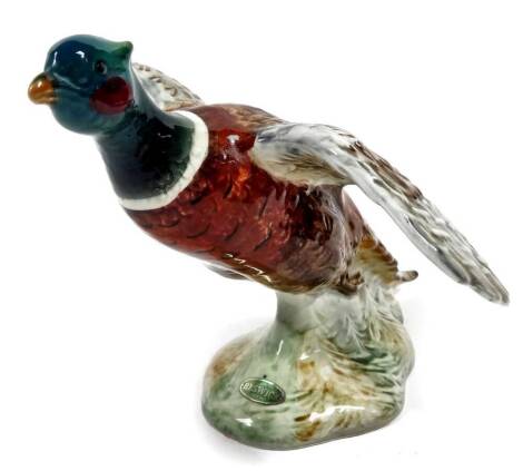 A Beswick figure of a pheasant, with winged outstretched, no. 850, impressed marks beneath, 13cm H.