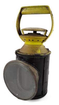 An early 20thC British Rail lantern, in yellow and black colour way, of cylindrical form, with front glass and fixed handle, 29cm H.