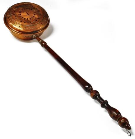 A late 19thC pierced copper warming pan, with turned fruit wood handle, 115cm L.