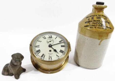 A 20thC Smith Empire brass bulkhead clock, of plain cylindrical form, with 14cm Dia. Roman numeric dial, subsidiary second hand and single winding hole, 8cm H, a heavy worked metal figure of a dog and a J H Wright, Lincoln, two coloured stoneware flagon w