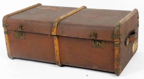 An early 20thC pressed leather steamer trunk, with part wooden banding, leather handles and fitted interior, with labels, 33cm H, 88cm W, 49cm D.