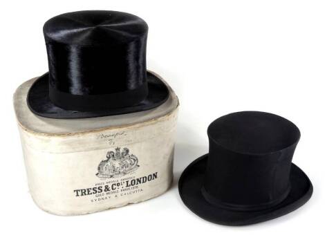 A 20thC Tress & Co top hat, with plain band, 15cm H, interior measurements 19cm x 16cm, and an Austin Reed collapsible top hat, interior measurement 20cm x 16.5cm, with one box.