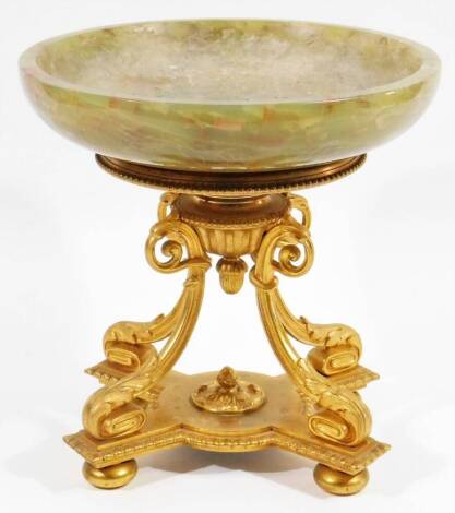 A Regency type gilt metal and onyx centrepiece, with shallow bowl raised on a quadruple scroll stem with bead work, on an egg shaped platform base terminating in compressed orb feet, 25cm H, 24cm Dia.