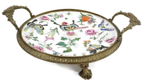 A Chinese export porcelain plate, of circular form, with metal mounts, now a serving dish, with elaborate bouquet handles, polychrome decorated to the centre with various insects, butterflies and flowerheads, predominately in pink, green and blue with gil