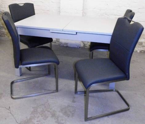 A set of four ex-display contemporary dining chairs, with chrome coloured supports in grey leather type material, 99cm H, labelled was £260 now £130 and a table.