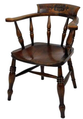 An ash and elm smoker's bow chair, with carved cresting rail initialled AOF2105, with turned supports, shaped seat and ring turned front legs, 79cm H.