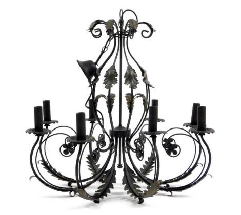 A metal eight branch chandelier, with inverted leafy capped S scroll supports and candle dish holders, on a central cylindrical stem, 74cm H.