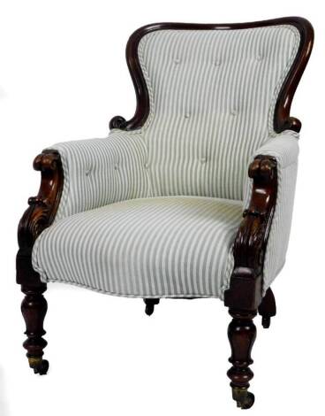 A Victorian mahogany chair, with scroll back, overstuffed with button back material to the arms and back, with serpentine seat in Regency type stripe material, on acanthus front legs terminating in castors, 110cm H.