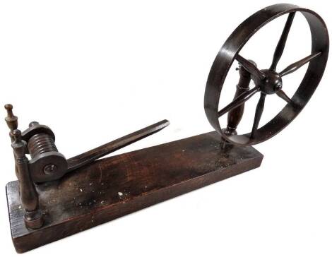 A small fruitwood table top spinning wheel, with spoked wheel, rectangular base, etc., 51cm L.