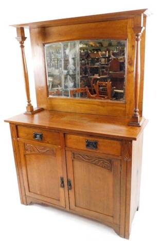 A late 19thC Art Nouveau mirror back side cabinet, the bevel glass flanked by turned supports, two frieze drawers and a double cupboard, 175cm H, 114cm W, 47cm D.