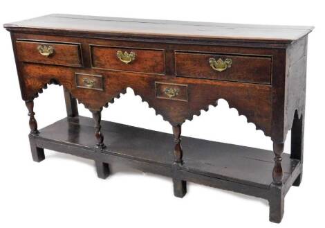 An 18thC oak dresser base, the rectangular plank top raised above three frieze drawers and two further drawers beneath, on turned front supports joined by an undertier, on block feet, 78cm H, 150cm W, 37.5cm D.