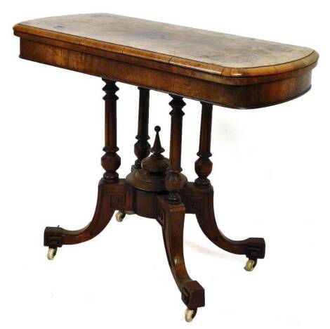 A Victorian walnut foldover card table, the rounded inlaid top, on quadruple turned supports, terminating in inverted legs with castors, with a later baize set interior, when closed 76cm H, 90cm W, 47cm D. (AF)