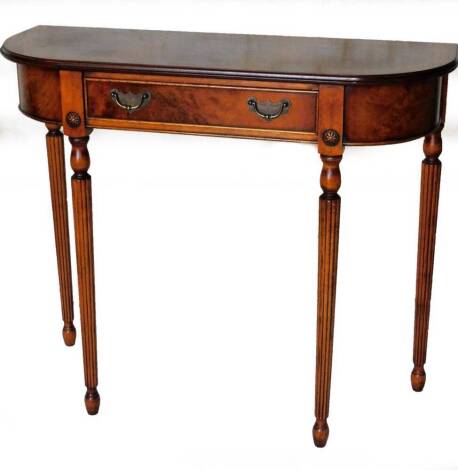 A 20thC mahogany and burr wood finish hall table, the shaped top with a wide crossbanding above a cockbeaded frieze drawer, on cylindrical reeded tapering legs, 78cm H, 92cm W, 33cm D