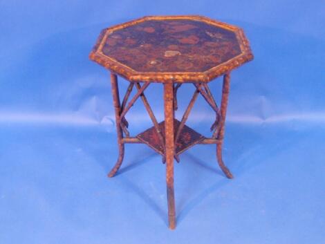 A Victorian bamboo framed octagonal window table with Japanese lacquer top and under shelf