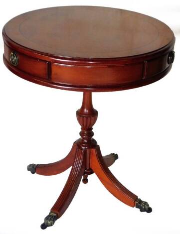 A 20thC yew wood drum table, with rotating top and three drawers, 58cm H, 50cm Dia.