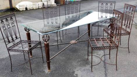 A large Moroccan dining table, and a set of six wire work metal patio chairs with cushions, glass topped table, chairs 100cm H. The upholstery in this lot does not comply with the 1988 (Fire & Fire Furnishing) Regulations, unless sold to a known exporter 