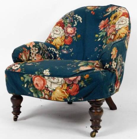 An Edwardian oak stained chair, with floral covering on turquoise ground, on turned front legs, terminating in castors, 85cm H.