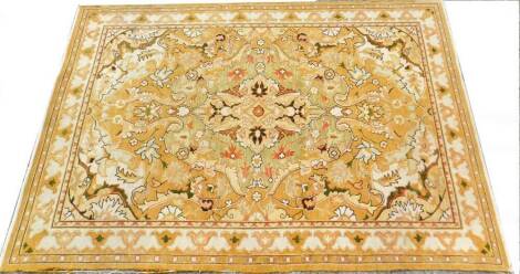 An Indian Soumac carpet, with a geometric and floral bell flower pattern, predominately in yellow and orange, original cost £1430, 260cm x 165cm.