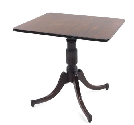 A early 19thC mahogany occasional table, the moulded rounded tilt top raised on a reeded support terminating in sabre legs with compressed feet, 72cm H, 64cm W, 76cm D.