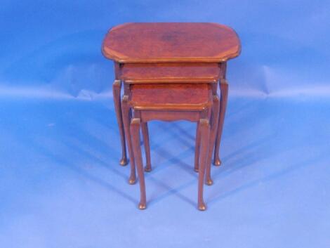 A 1920's walnut nest of tables