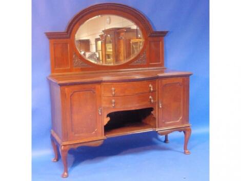 A 1920's walnut side board with arched mirror back