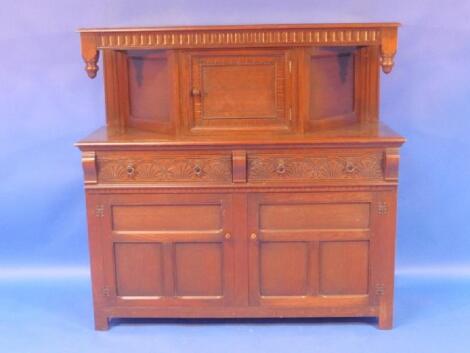 A reproduction oak court cupboard