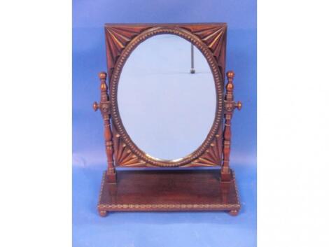 A 19thC Anglo Indian dressing table mirror with moulded frame turned upright