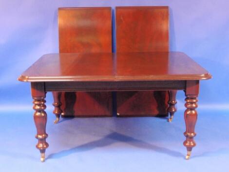 A reproduction Victorian mahogany extending dining table with pull out