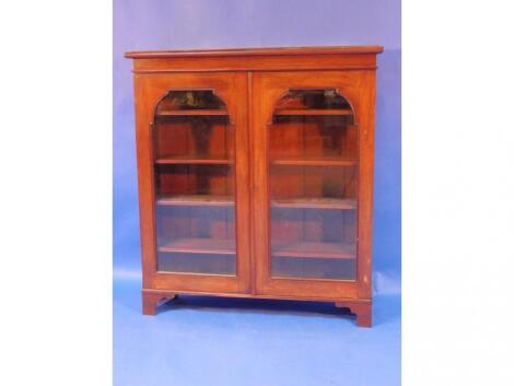 A Victorian mahogany bookcase with two glazed doors and bracket feet housing