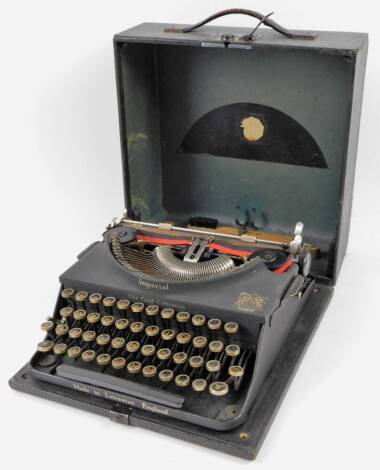 An early 20thC Imperial portable typewriter, in black, with articulated buttons in pressed case, 30cm W.