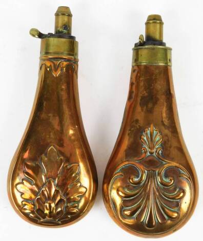 Two similar early 20thC copper and brass powder flasks, each with articulated tops of tear drop form, raised with flowers and scrolls, 21cm H. (2)