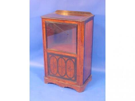 A late Victorian walnut music cabinet with ebonised and scratch carved decoration