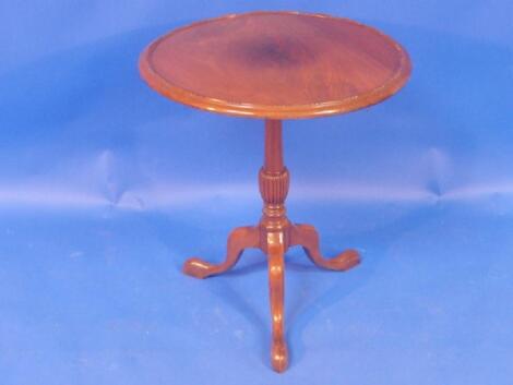 A Georgian style walnut supper table with tilt top and tripod base