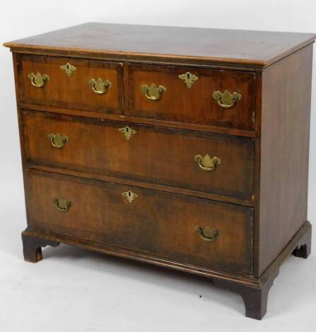 An 18thC walnut chest, of two short and two long drawers, each with a wide crossbanding, on bracket feet, partially inlaid top and plate back swan neck handles, 83cm H, 87cm W, 54cm D.