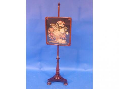 A Victorian mahogany pole screen with turned stem trefoil base with turned