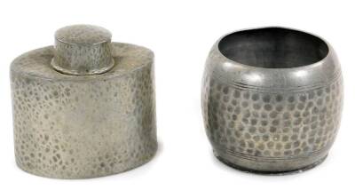 A Liberty & Co Arts and Crafts pewter tea caddy, of oval form with circular lid, no. 0614, impressed marks beneath, 9.5cm H, and a KL pewter bowl, partially hammered. (2)