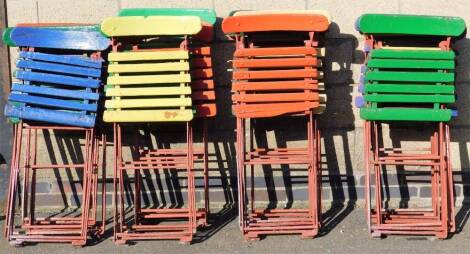 Various early 20thC wrought iron and wooden slatted folding deck chairs, partially painted in blue, red, green, etc. when closed 104cm H.