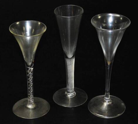 An 18thC toasting glass, of plain tapered conical design raised upon a conical foot, 18cm H, an 18thC trumpet wine glass, with double air twist stem and raised upon a conical foot, 18.5cm H and an 18thC conical wine flute, with tapered air twist stem and 