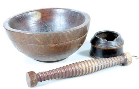 A late 18thC/early 19thC turned sycamore bowl, 29cm Dia., a wooden pestle with carrying hook and a small wooden mortar (AF). (3)