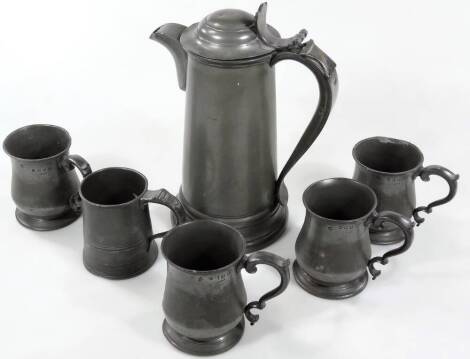 An early 20thC pewter flagon, of tapering cylindrical form, with shaped handle and spout and removable compressed domed lid, 33cm H, and various other pewter tankards. (a quantity)