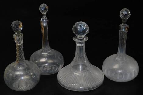 A pair of Victorian slice cut glass decanters, with compressed spherical bodies and slender necks and facet cut stoppers, a cut glass ship's decanter, and another. (4)