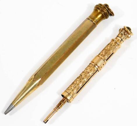 An early 20thC Hicks of New York propelling pencil, partially engine turned, with cylindrical body and articulated end, with ring top, unmarked, 9cm W and a rolled gold pencil. (2)