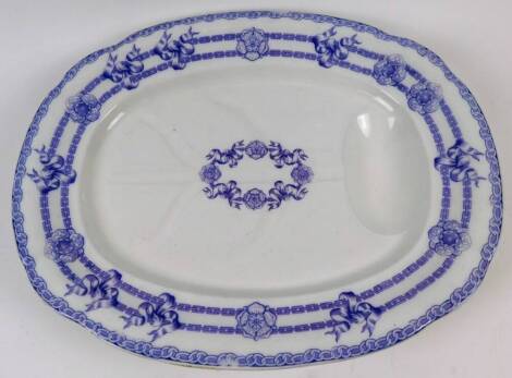 A Victorian Staffordshire pottery Indian pattern turkey drainer serving dish, of shaped oval form, with moulded well, marked to the back, 56cm wide.