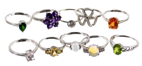 Ten modern silver dress rings, each stone set of varying designs, to include floral clusters, three stone design, single stone set rings, etc. (10)