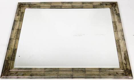 A rectangular mirror, with bevelled glass and shaped scrubbed silvered frame, 96cm x 121cm.