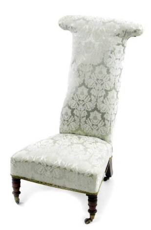 A Victorian prie dieu chair, with T shaped back, overstuffed in later floral material, on turned front legs, 97cm H.