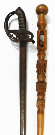 A dress sword with shaped blade, pierced handle and turned grip with orb pommel, 99cm W and a turned African tribal staff. (2)